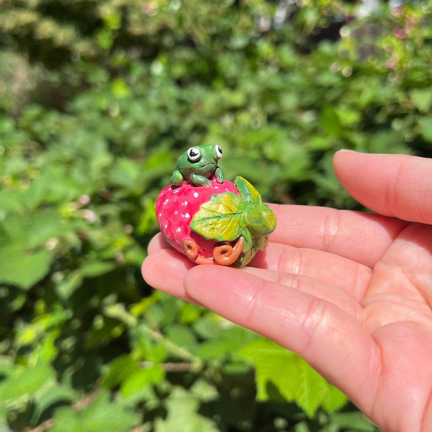 Handmade polymer clay frogs on fruits figurines