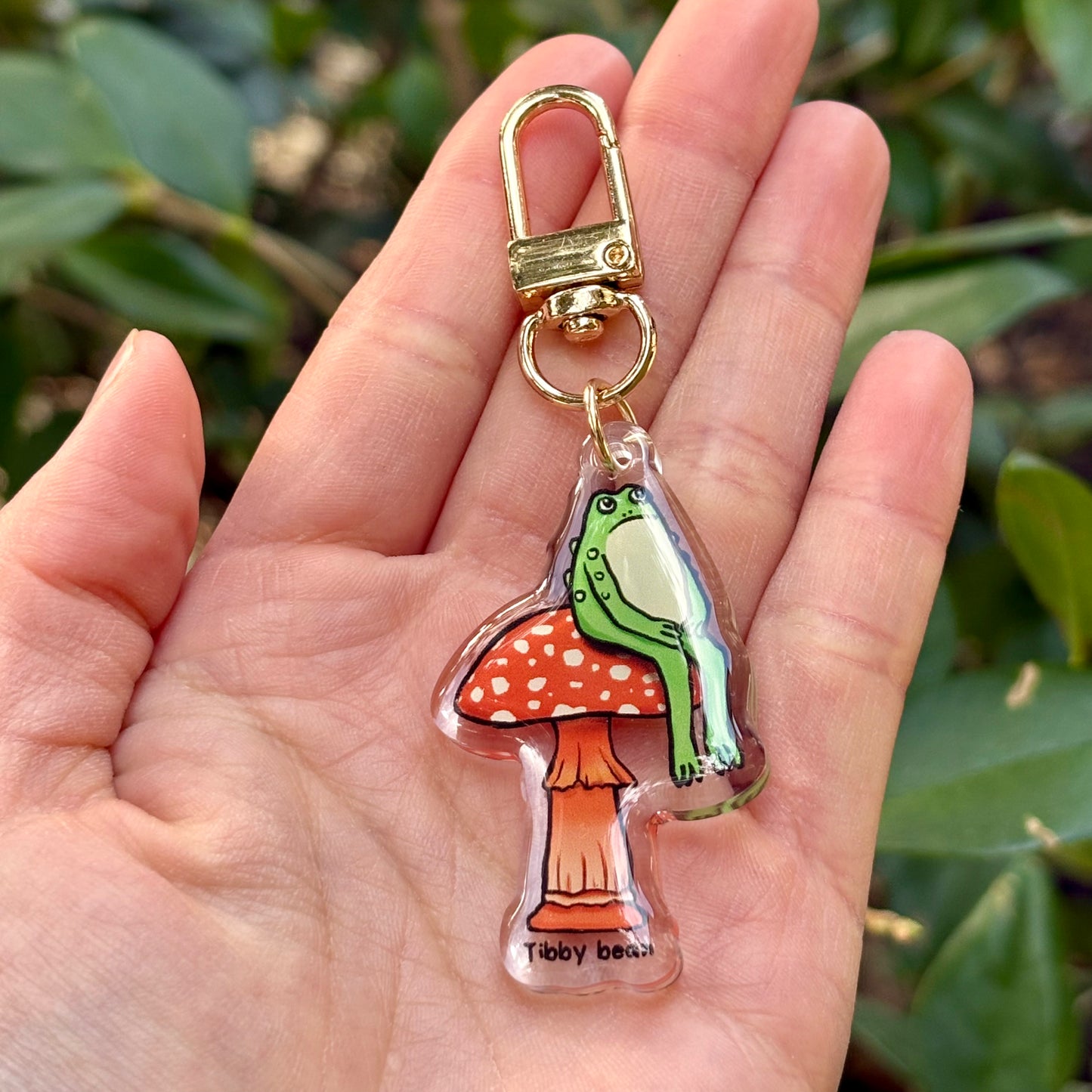 Acrylic sitting toad on mushroom keychain
