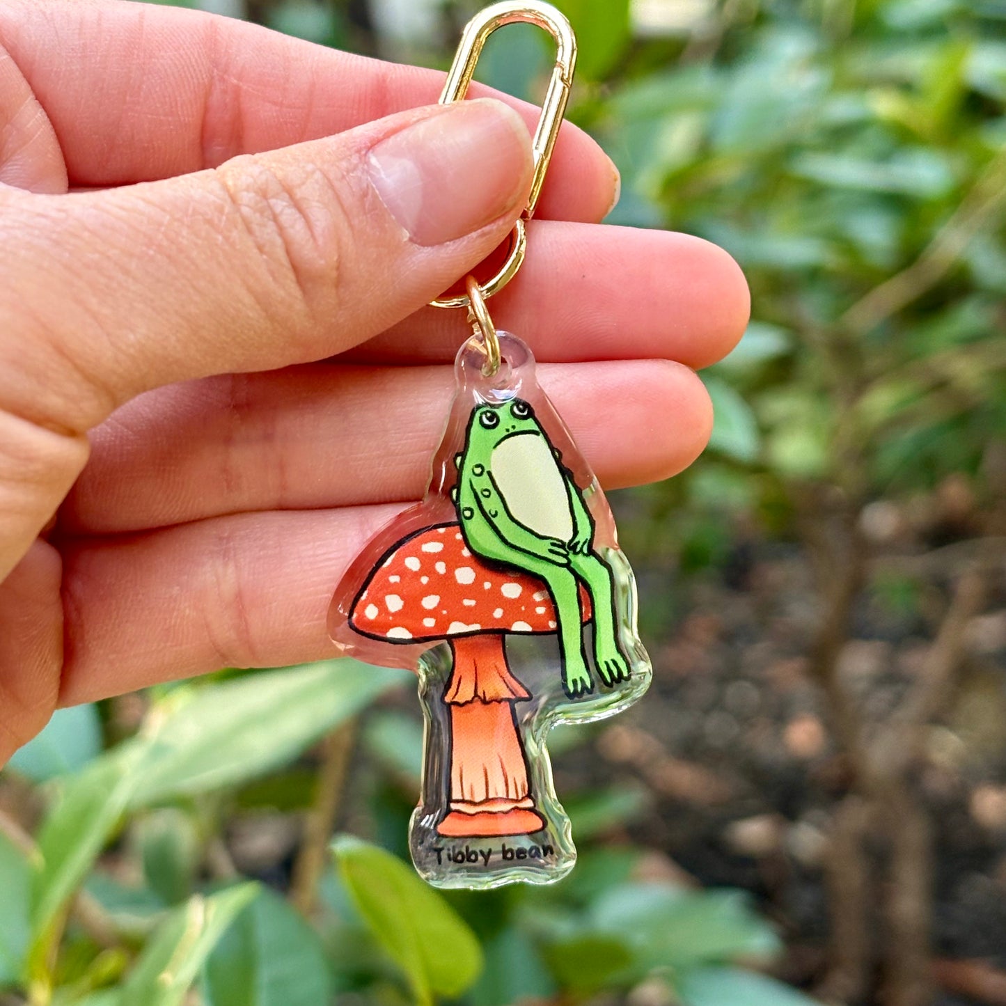 Acrylic sitting toad on mushroom keychain