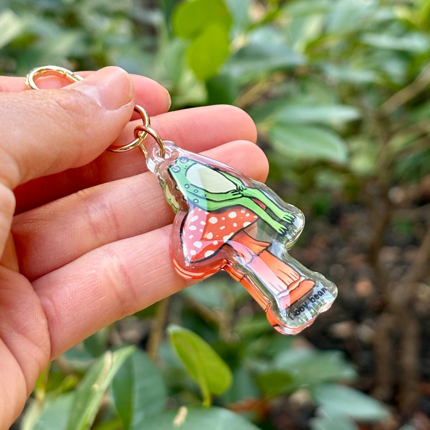 Acrylic sitting toad on mushroom keychain