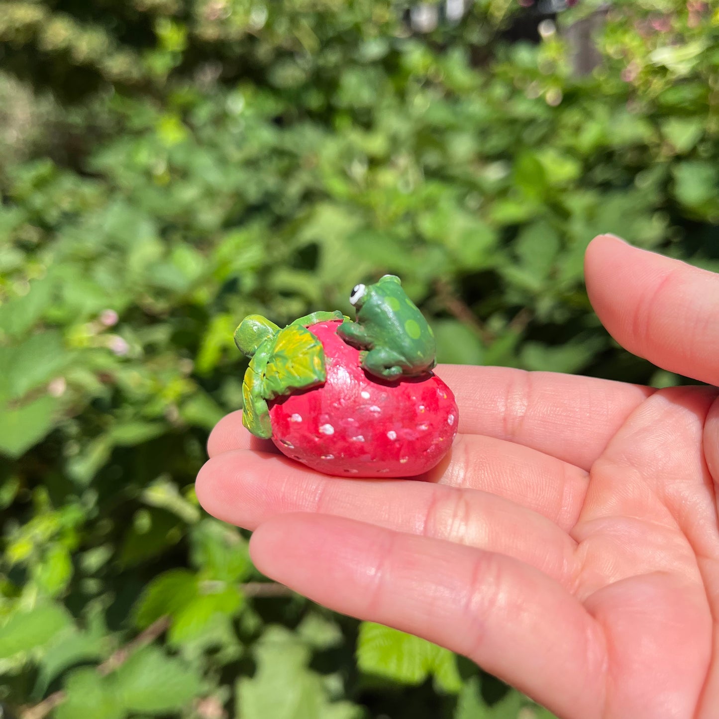 Handmade polymer clay frogs on fruits figurines