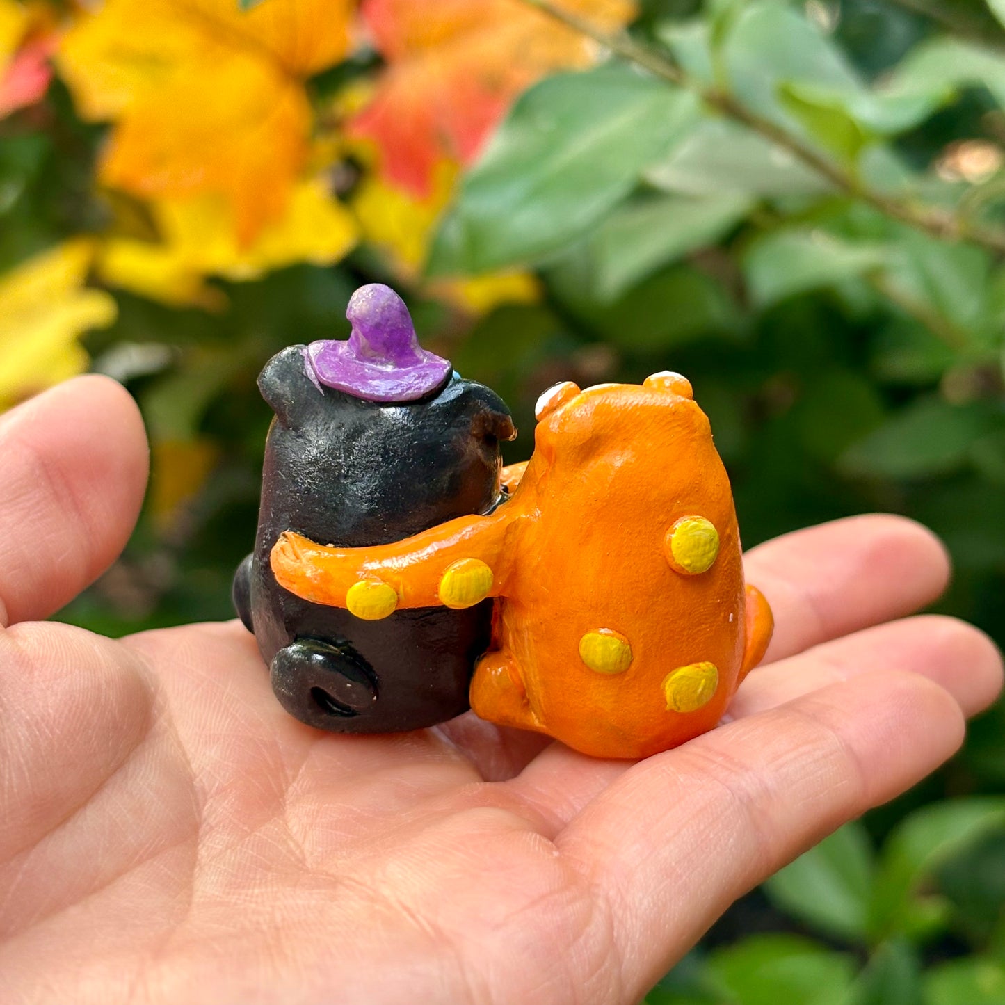 Handmade hugging pug and frog figurine