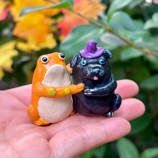 Handmade hugging pug and frog figurine