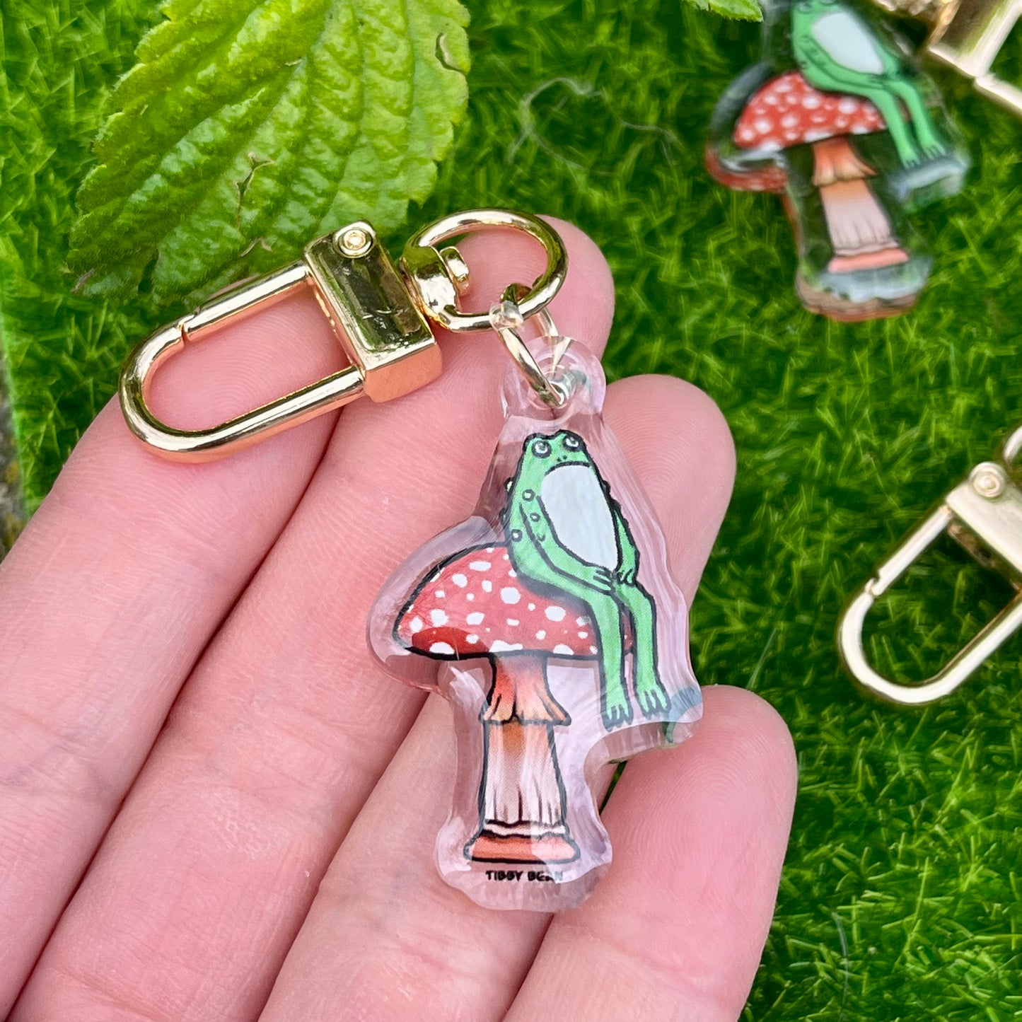 Acrylic sitting toad on mushroom keychain