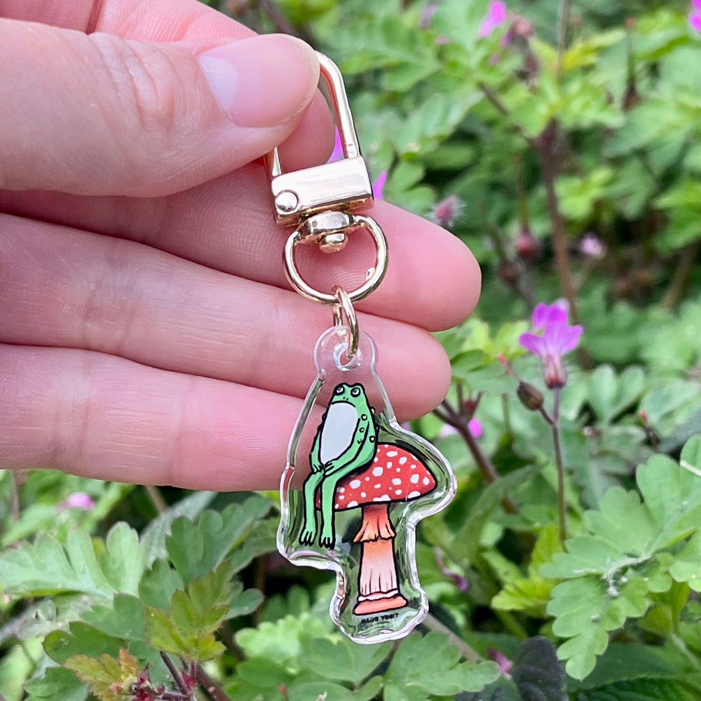 Acrylic sitting toad on mushroom keychain