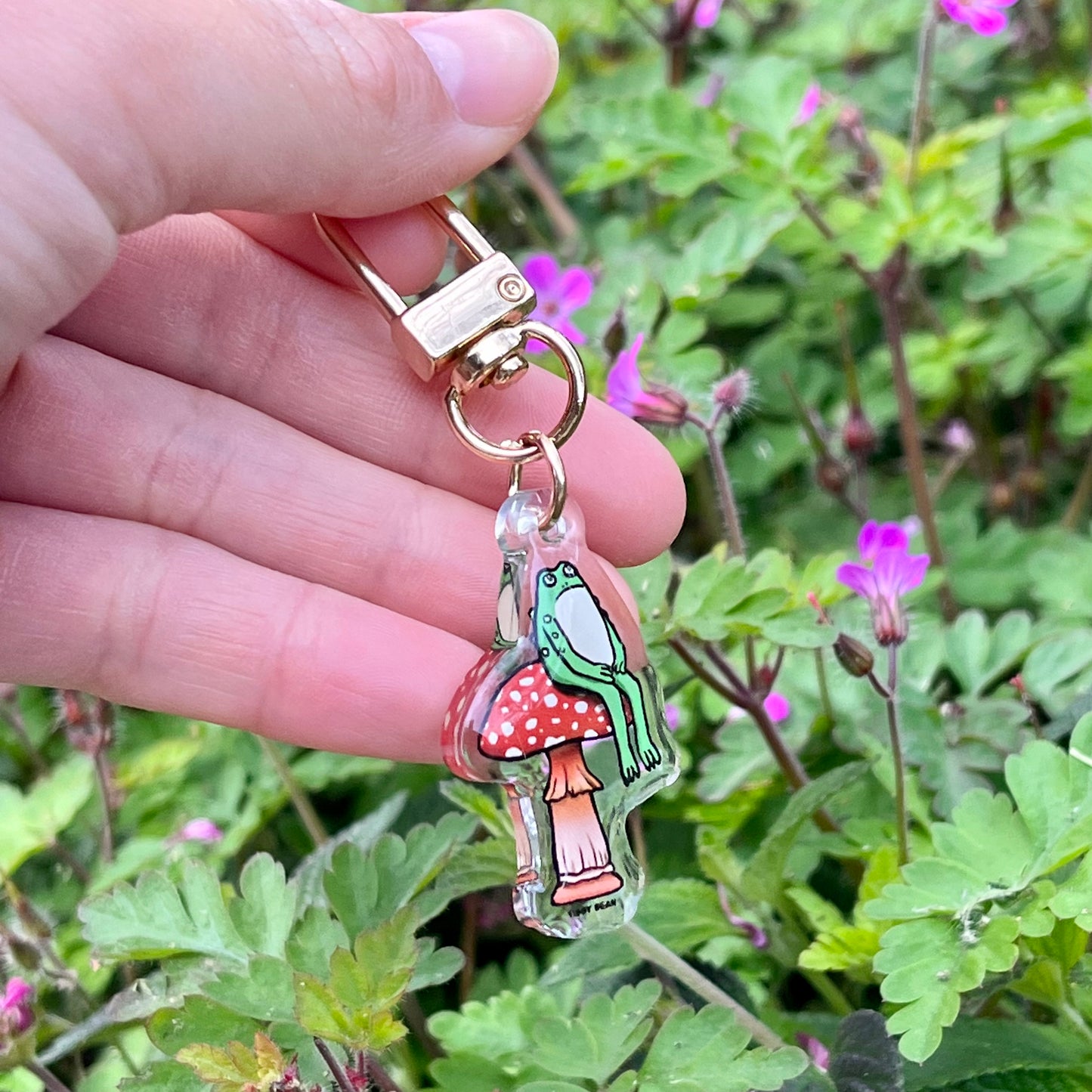 Acrylic sitting toad on mushroom keychain