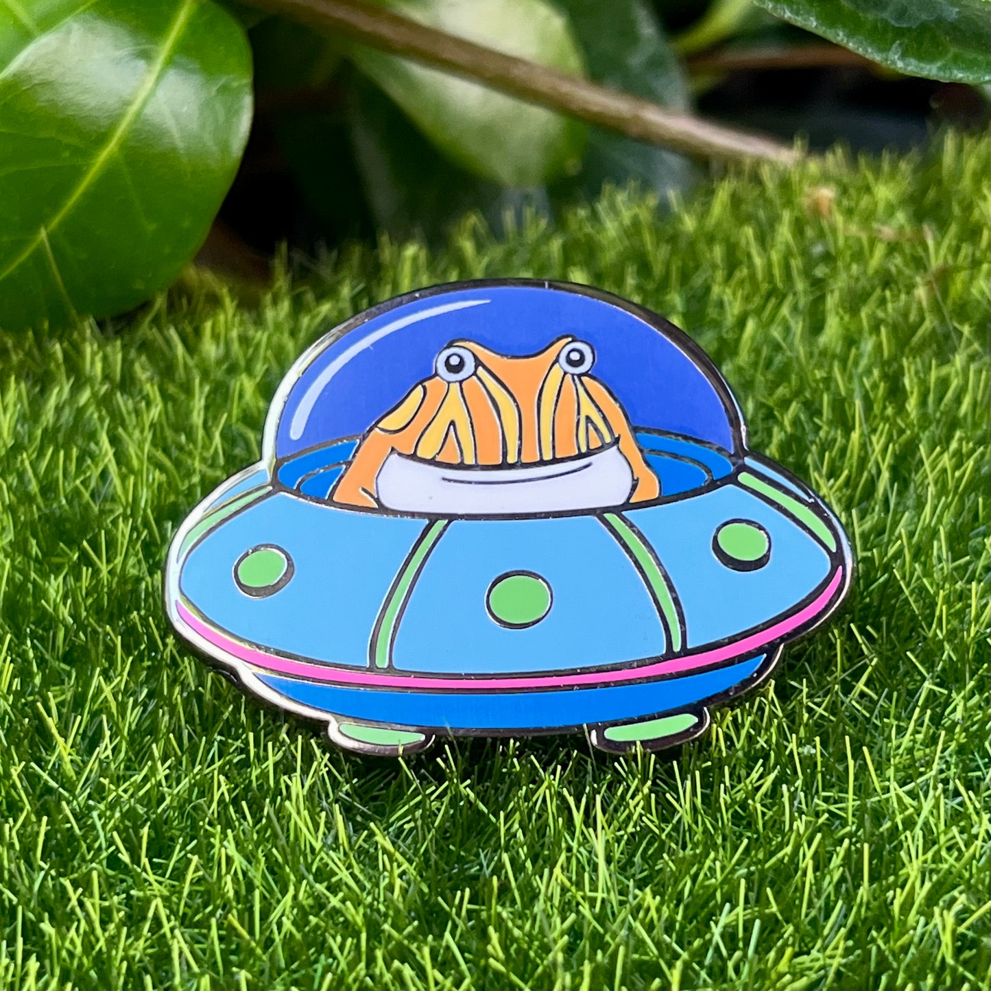 Tibby the frog in a UFO enamel pin