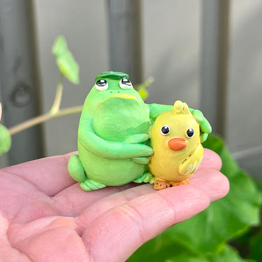 Handmade hugging frog and duck friend figurine