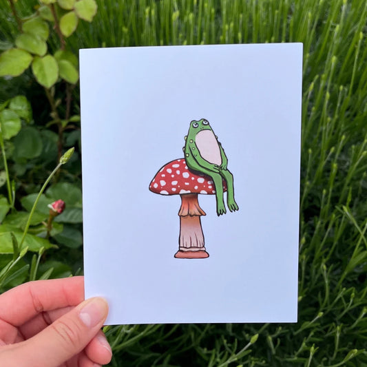 Grumpy Green Toad Sitting on Mushroom Greeting Card